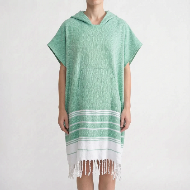 Person wearing a unisex hooded beach changing poncho after watersports. Ideal for privacy & warmth.