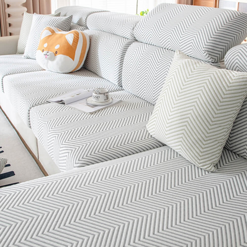 Detailed shot of the elastic band and anti-slip features of the ice silk stretch sofa cover.