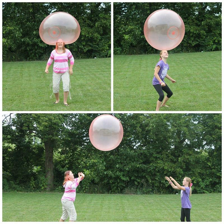 Kids having fun with a large, flexible inflatable bubble ball, a safe outdoor activity toy.