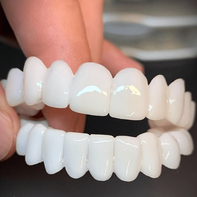Unisex instant smile enhancer cosmetic tooth covers for a confident, white smile.