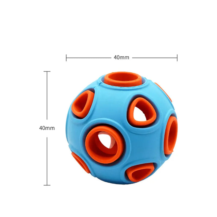 Puppy chewing on an interactive musical light-up dog toy ball, great for fetch