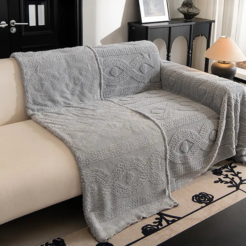 Elegant jacquard sofa blanket draped over a couch, adding warmth and style to living room