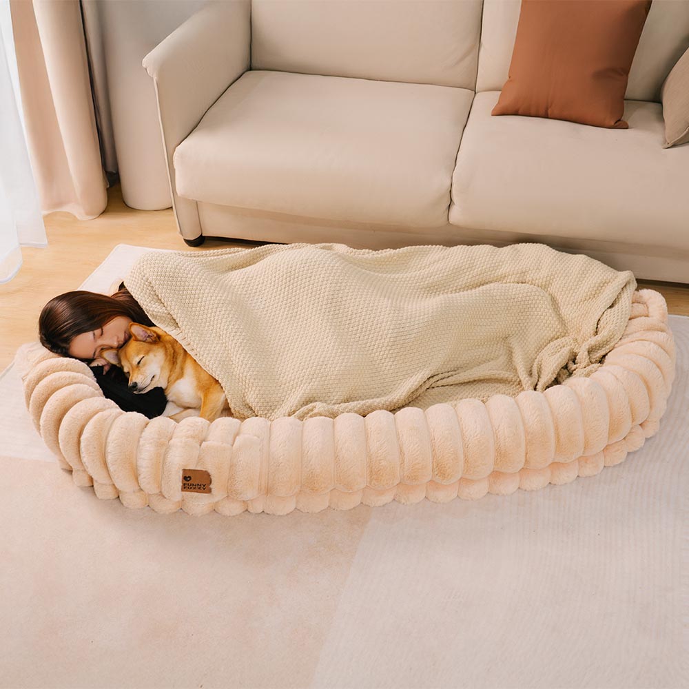 Large calming cuddle bed, designed for pet anxiety relief, plush and machine washable.