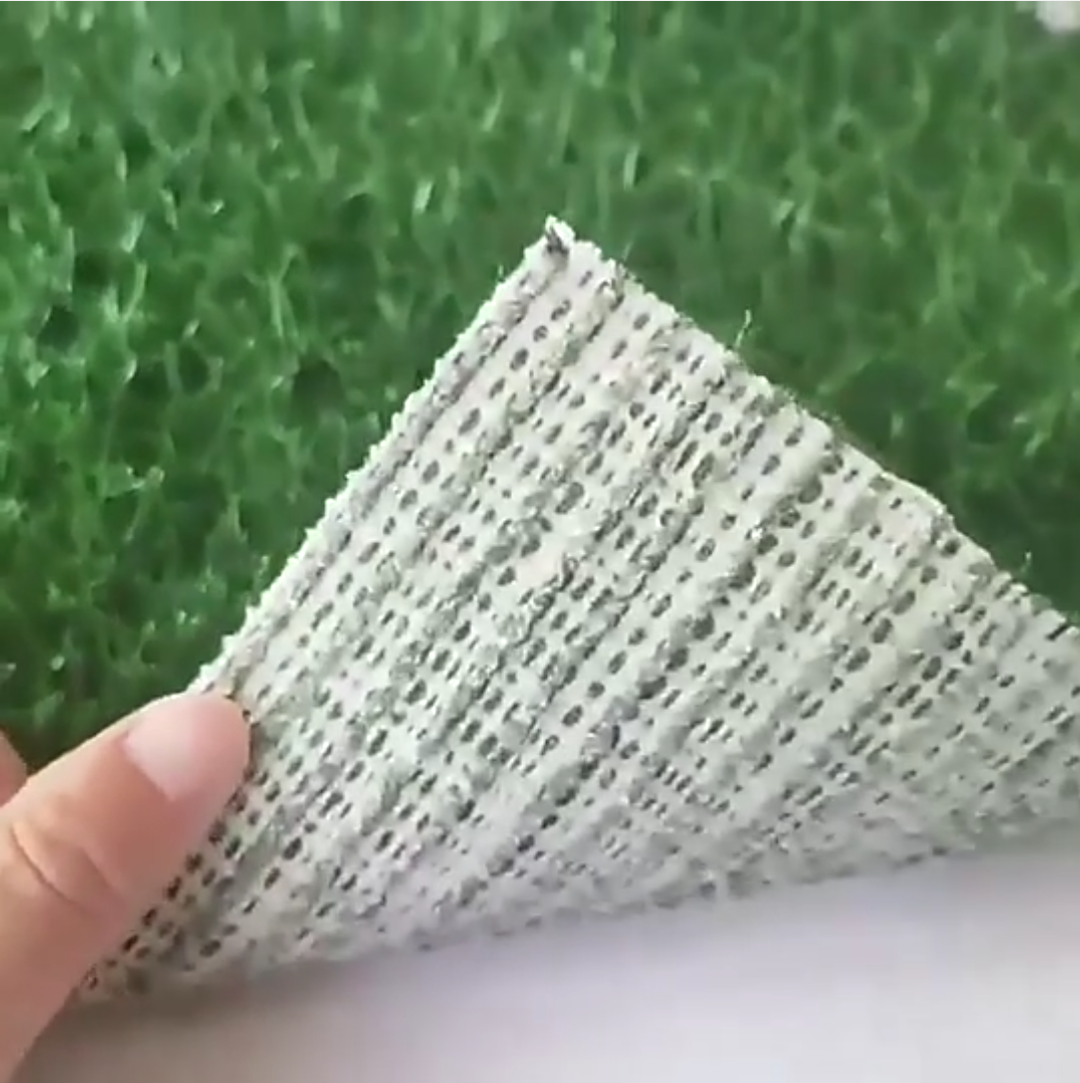 Pet training mat with artificial grass surface, leak-proof dog potty pad for indoor use.