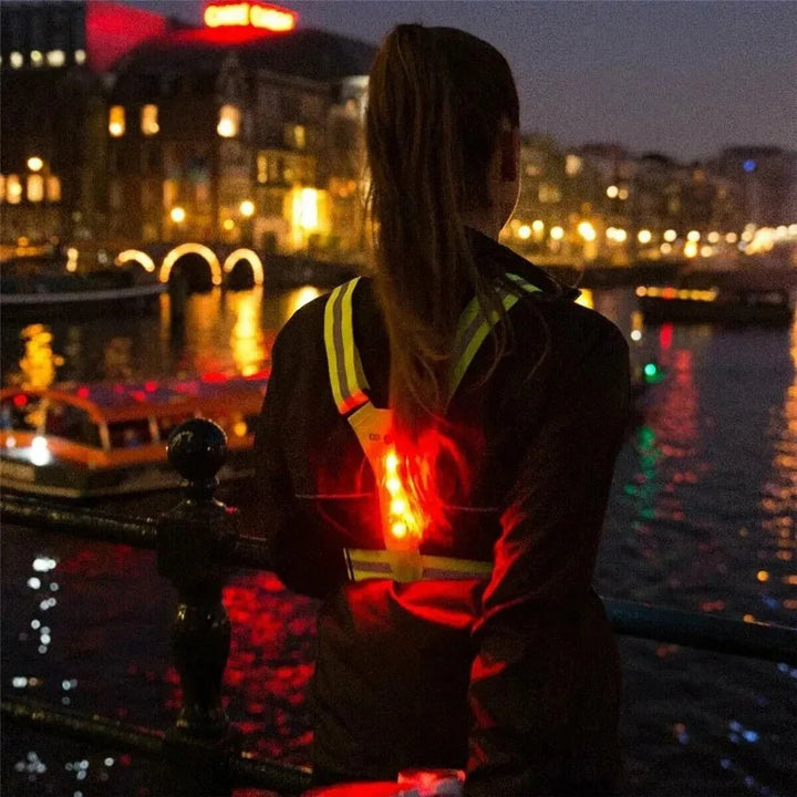 Adjustable reflective safety vest with LED lights, ideal for night cycling, walking, and outdoor activities.