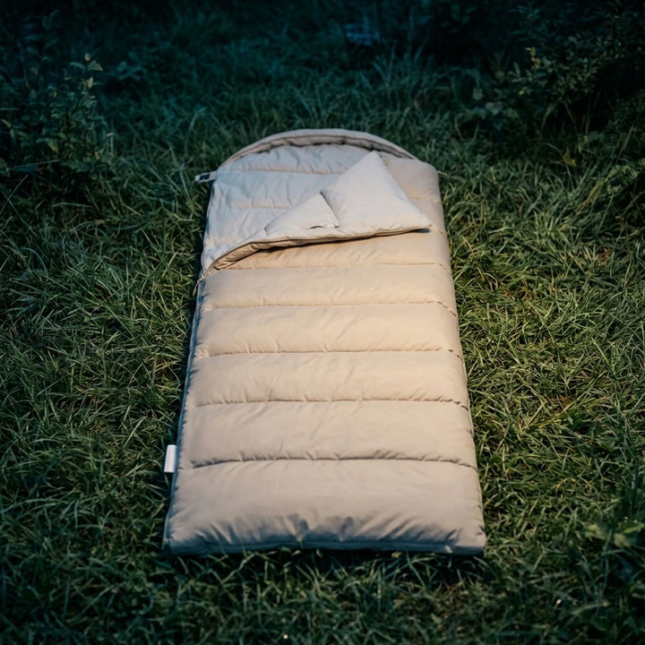 Unisex lightweight envelope sleeping bag for camping, hiking & travel. Three-season polyester design.