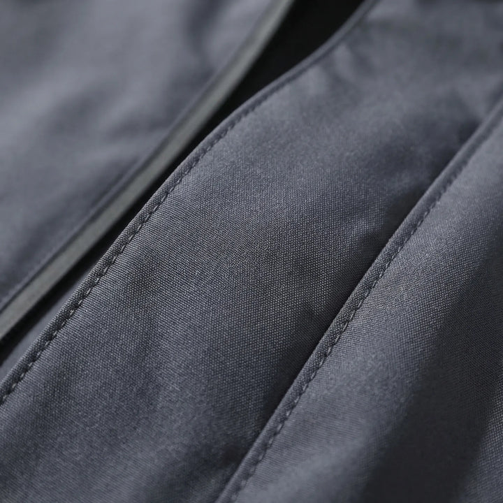 Packable unisex lightweight rain jacket with hood, ideal for travel. Weather-resistant activewear for trips.