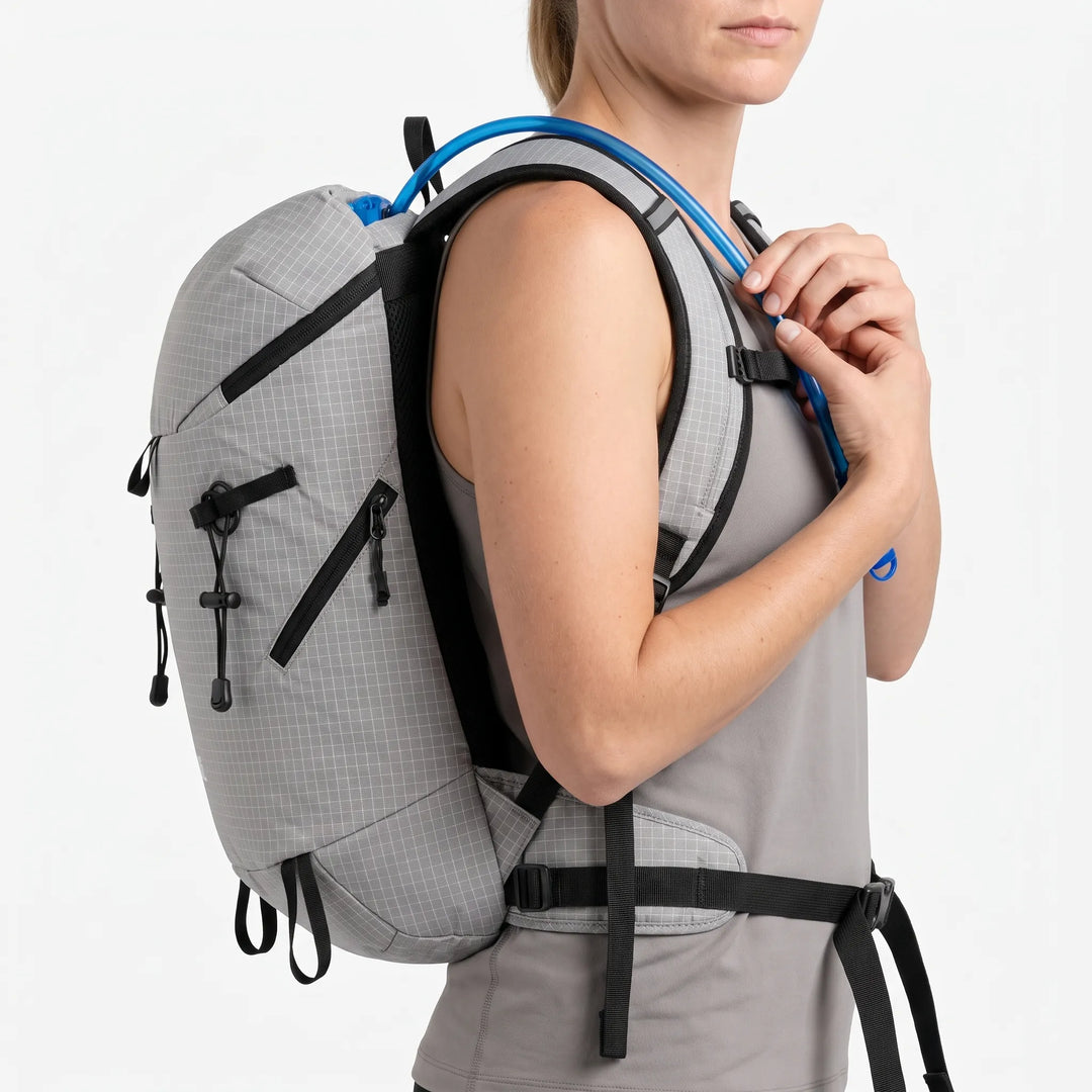 Person wearing a lightweight hydration hiking pack on a trail, ready for outdoor adventure & camping trips.