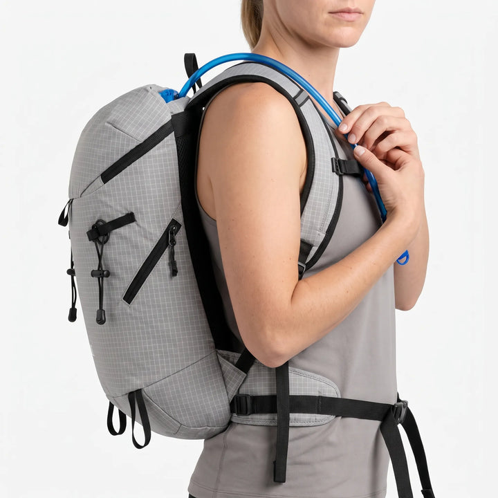 Person wearing a lightweight hydration hiking pack on a trail, ready for outdoor adventure & camping trips.