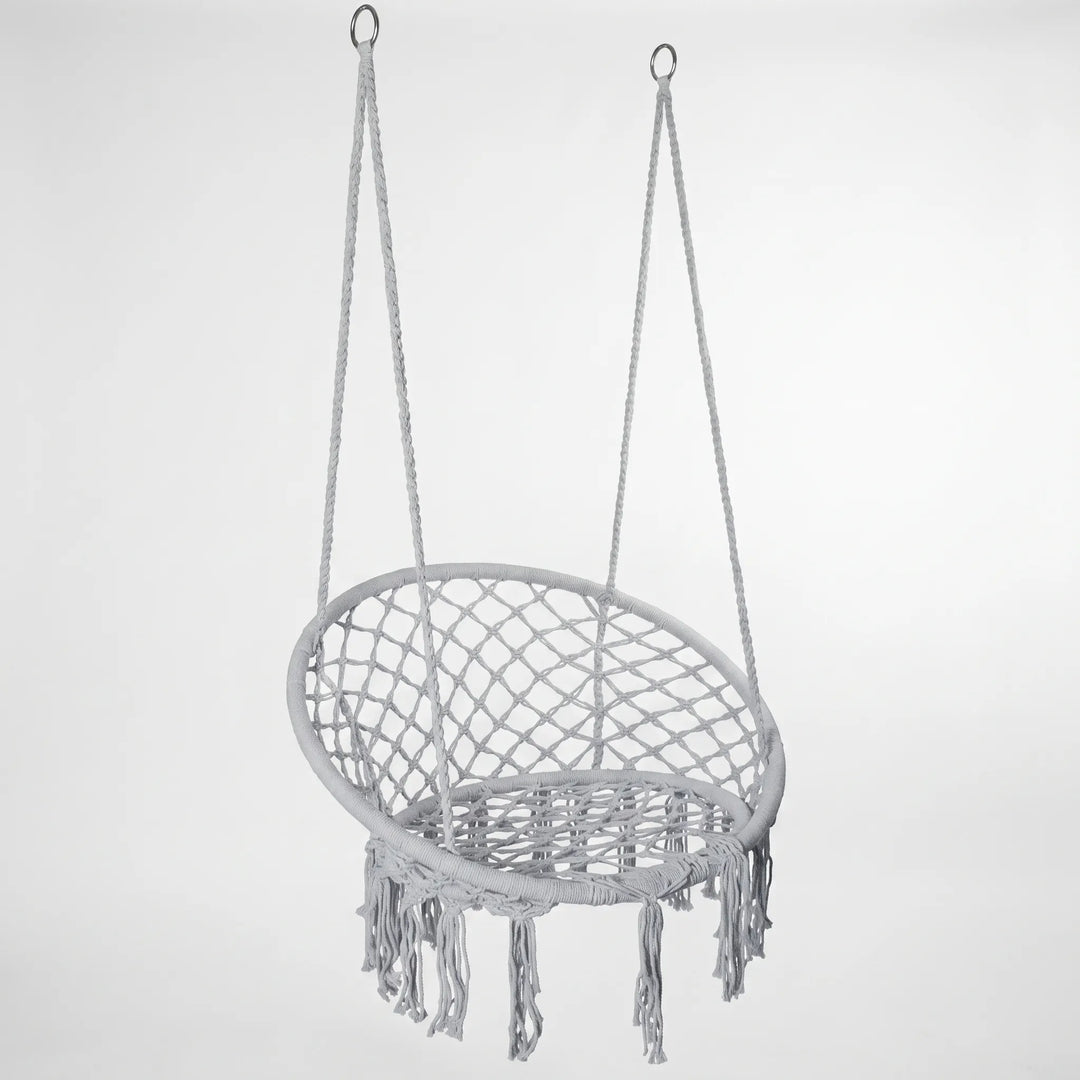 Close-up of the elegant macrame weave on a white hanging hammock swing chair, showcasing craftsmanship.