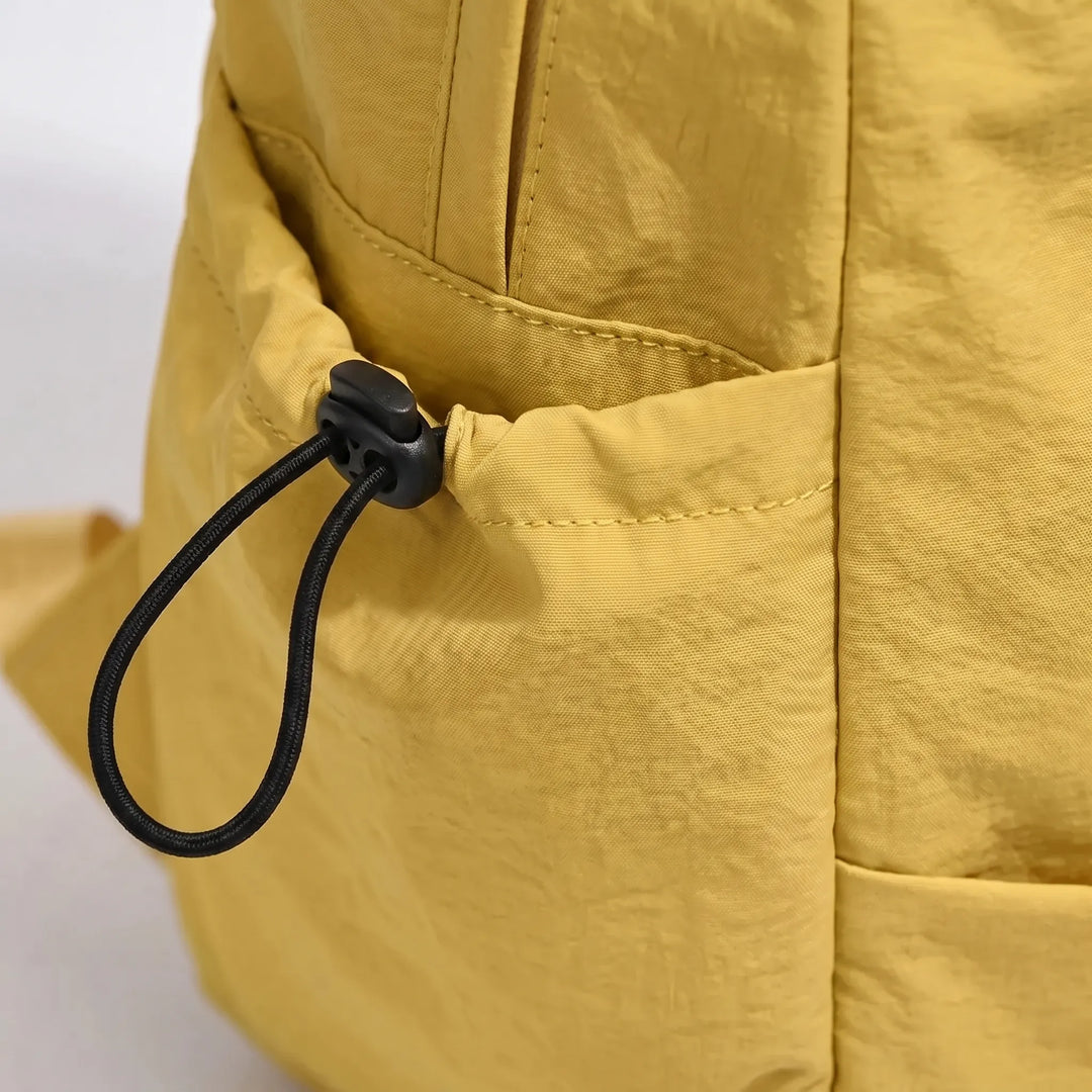 Sleek minimalist travel backpack, black nylon, versatile for everyday use, school, and work.