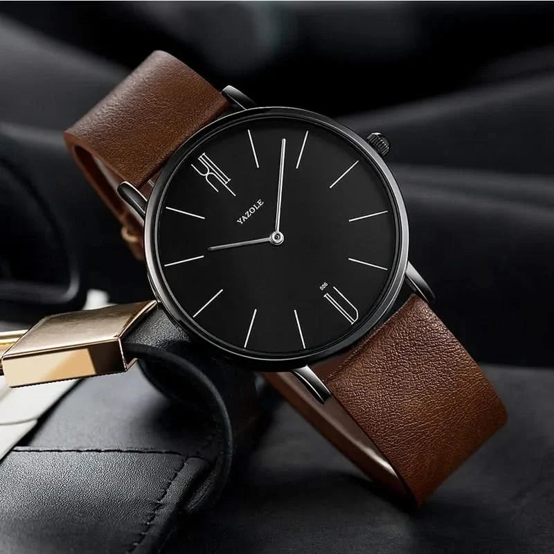 Unisex minimalist watch featuring a sleek stainless steel case and a classic black leather band.