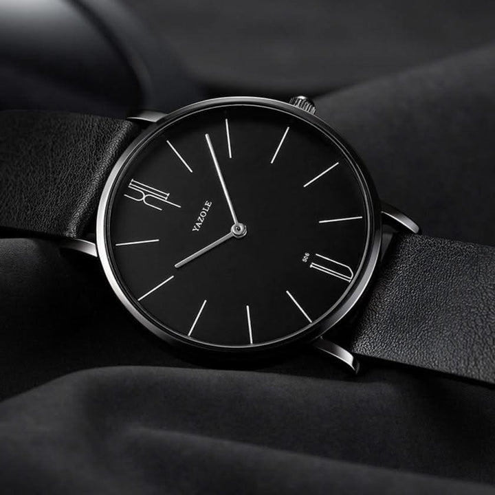 Unisex minimalist watch on a wrist, highlighting its elegant leather band and sleek stainless steel profile.