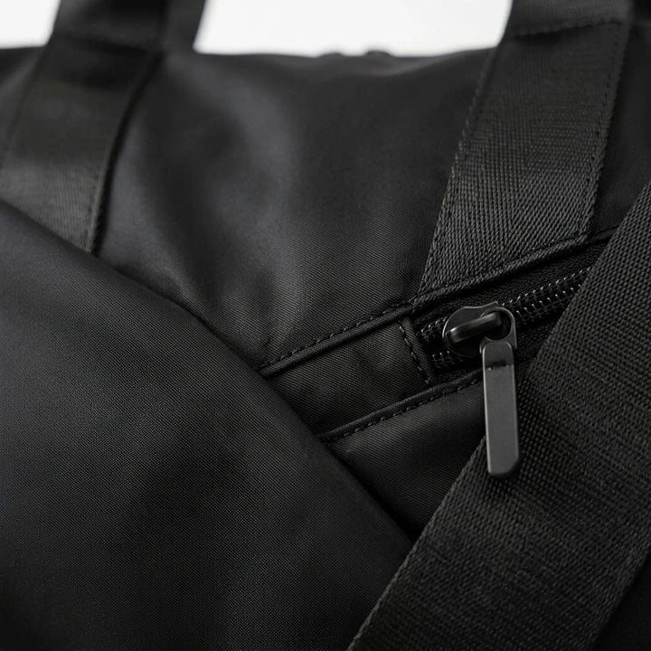 Man and woman carrying a versatile unisex gym duffel bag, ideal for sports, travel, and daily workouts.
