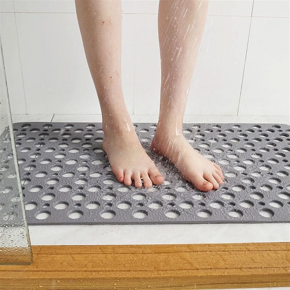 Anti-slip shower mat for bathroom safety, featuring robust suction cups and a comfortable textured surface.
