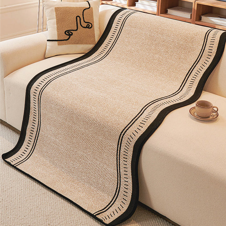 Full view of a gray non-slip chenille couch cover protecting a sofa, elegant wavy edge design for home decor.