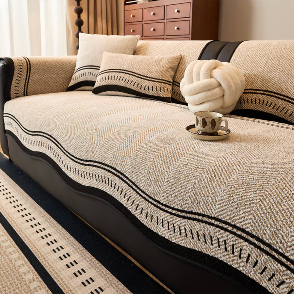 Pet-friendly herringbone chenille couch cover draped over a three-seater sofa, easy-care and durable.