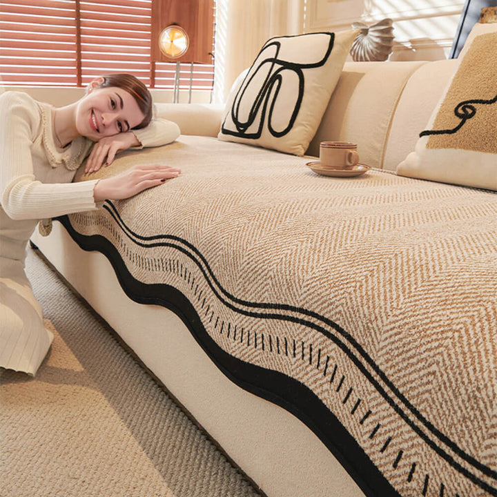Detailed shot of the wavy edges and plush chenille fabric of a non-slip sofa protector, home decor item.
