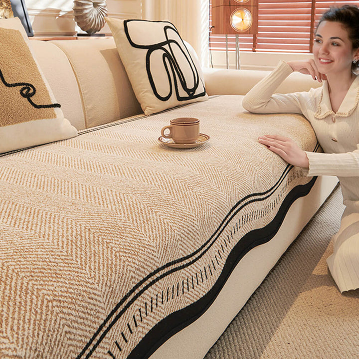 Non-slip backing visible on the reverse side of a herringbone chenille couch cover, ensuring stability.