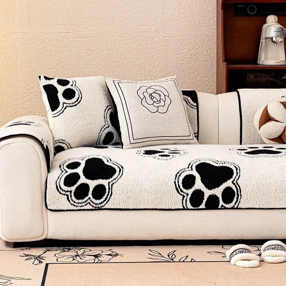 Washable pet-friendly sofa protector with distinct paw print pattern on fleece