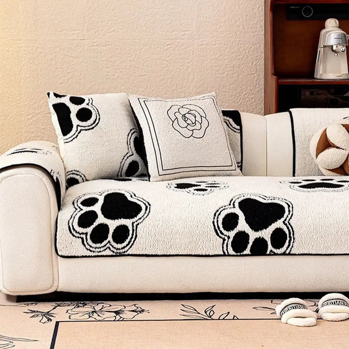 Washable pet-friendly sofa protector with distinct paw print pattern on fleece