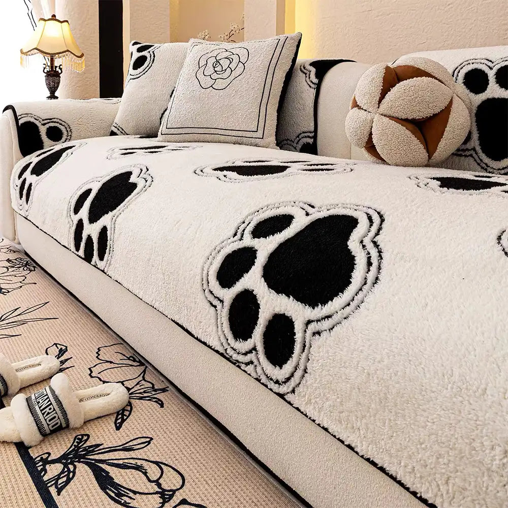 Close-up of paw print pattern on fleece sofa protector for pet owners