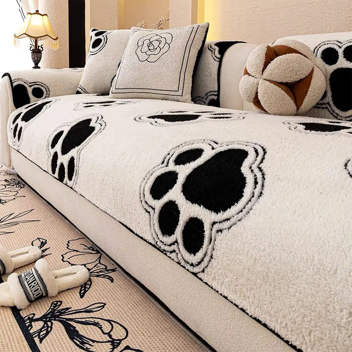 Close-up of paw print pattern on fleece sofa protector for pet owners