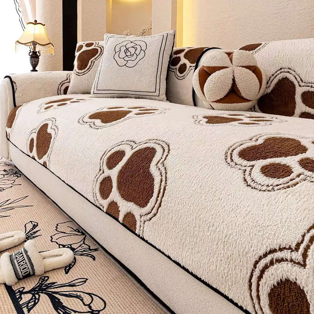 Non-slip paw print fleece couch cover protecting a sofa from pet use