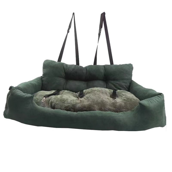 Small dog sleeping soundly in a cozy pet car booster seat console pad, providing pet comfort.