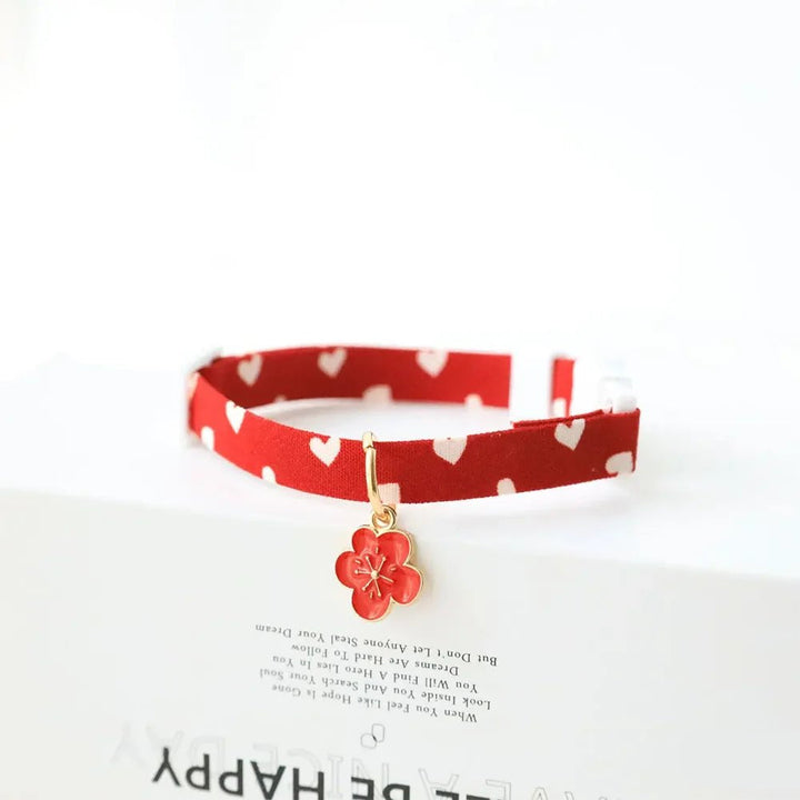 Orange pet collar with paw print design, adjustable, comfortable cotton polyester for pets.