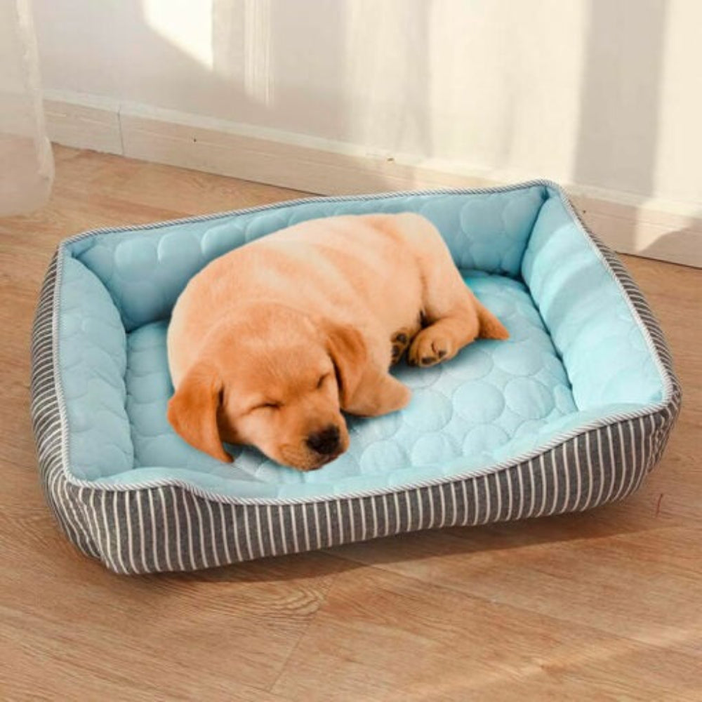 Dog enjoying a deep sleep on a rectangular pet cooling bed, perfect for hot summer days