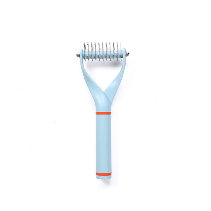 Unisex Pet Dematting Comb next to a pile of removed pet hair, proving its effectiveness as a grooming tool.