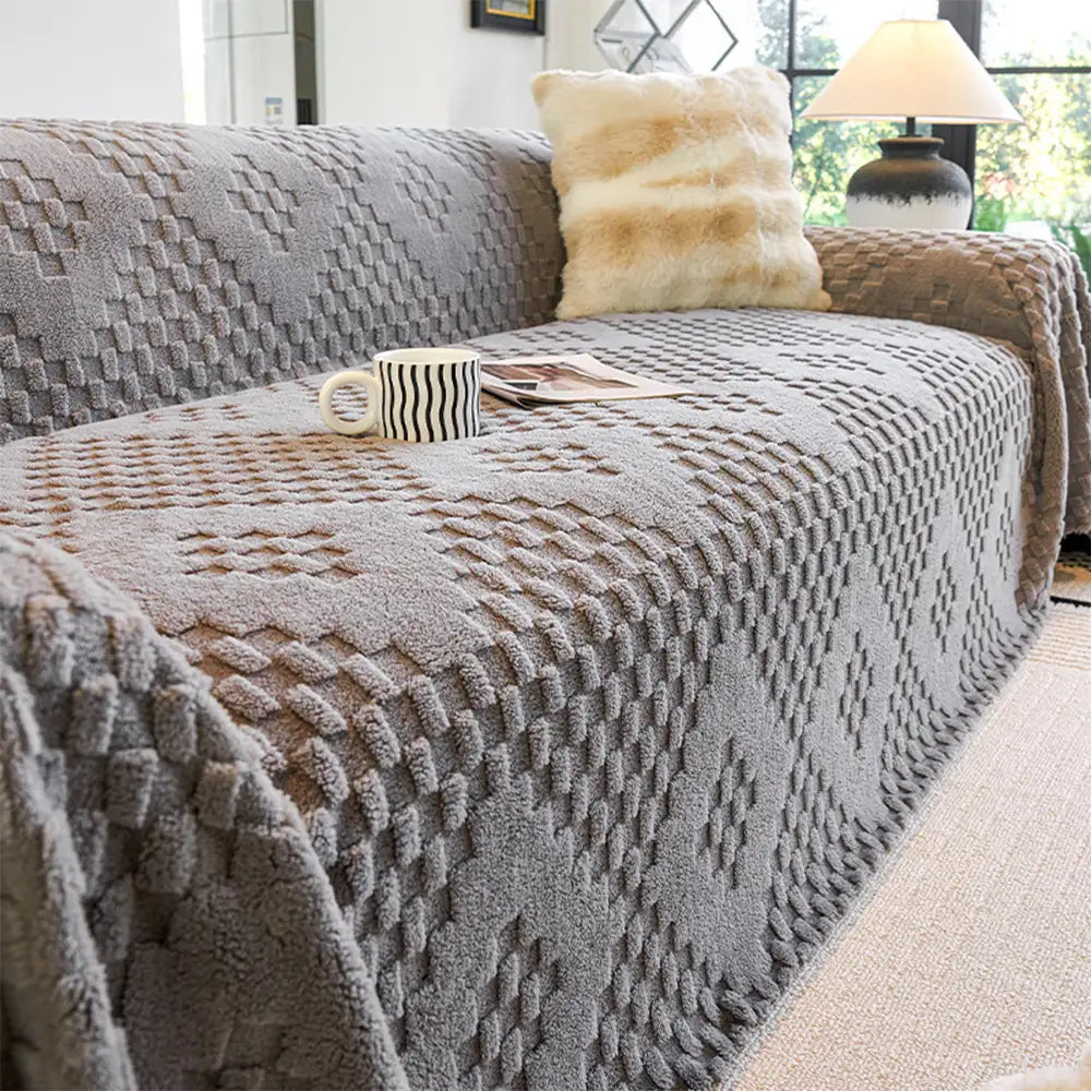 Unisex pet-friendly jacquard velvet sofa cover draped over a full sofa in a living room, scratch resistant.