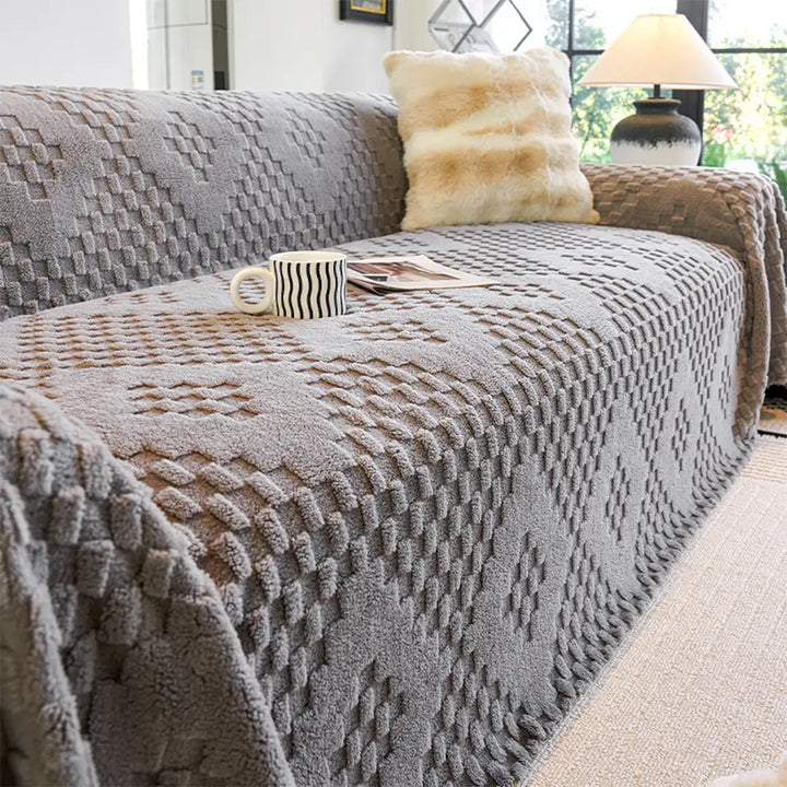 Unisex pet-friendly jacquard velvet sofa cover draped over a full sofa in a living room, scratch resistant.