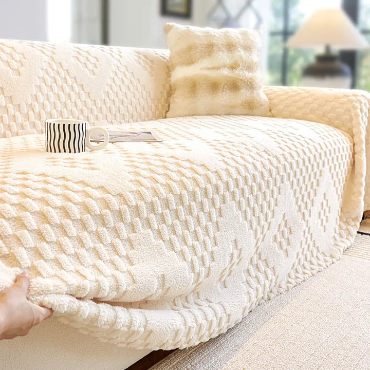 A cozy living room setting with a sofa adorned with a stylish jacquard velvet pet-friendly couch cover.