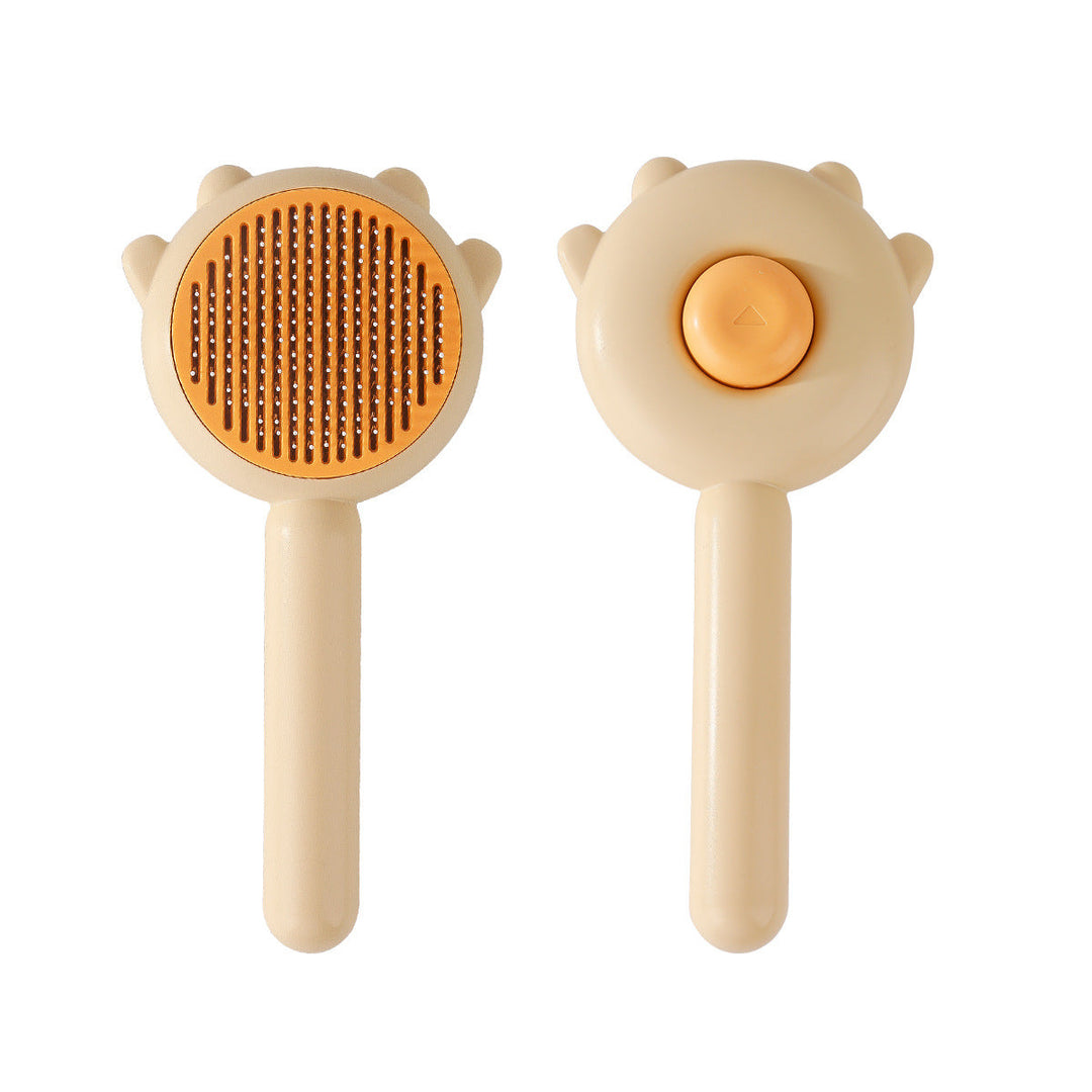 Hand holding a pet grooming brush, demonstrating ease of use for cat care.