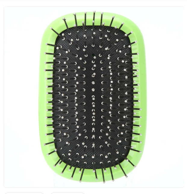 Close-up of pet grooming brush showing silicone grip and stainless steel detaching comb