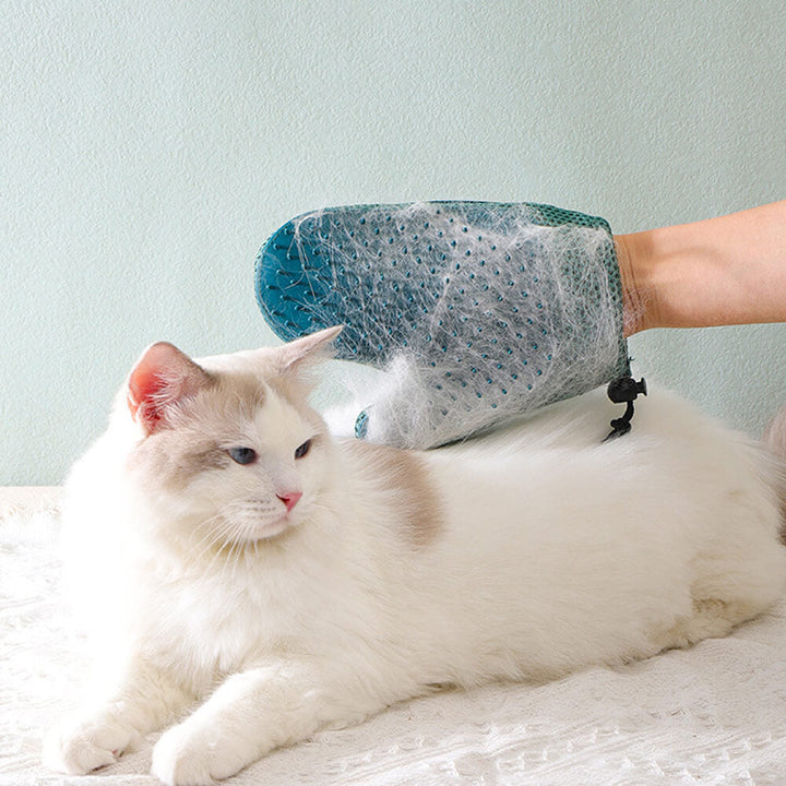 Silicone pet grooming glove with soft bristles, perfect for massaging & shedding.