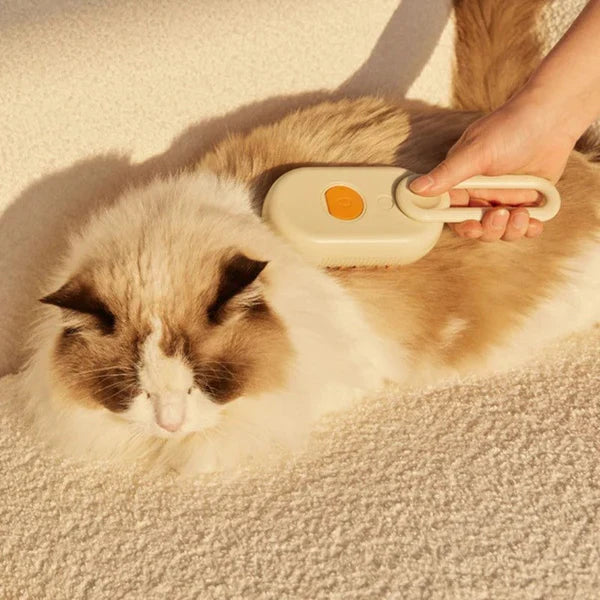 Hand holding a steam brush for pet grooming, emphasizing its comfortable and easy use