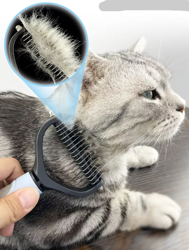 Close-up of the large grey dog grooming brush showing its fine teeth for undercoat removal.