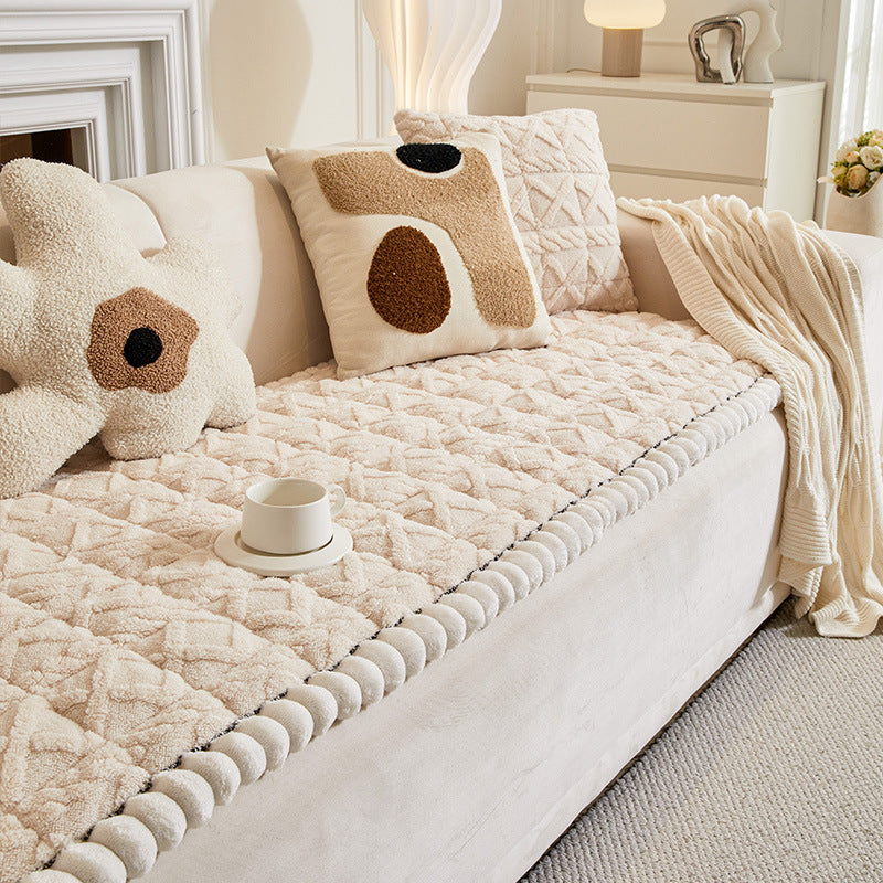 Bedroom scene with a comfy plaid couch cover, plush and anti-slip, adding warmth to decor.
