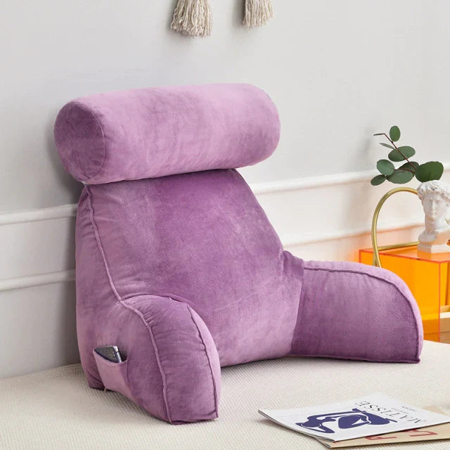 Stylish plush bed lounge pillow with arms, enhancing home comfort & reading experience.