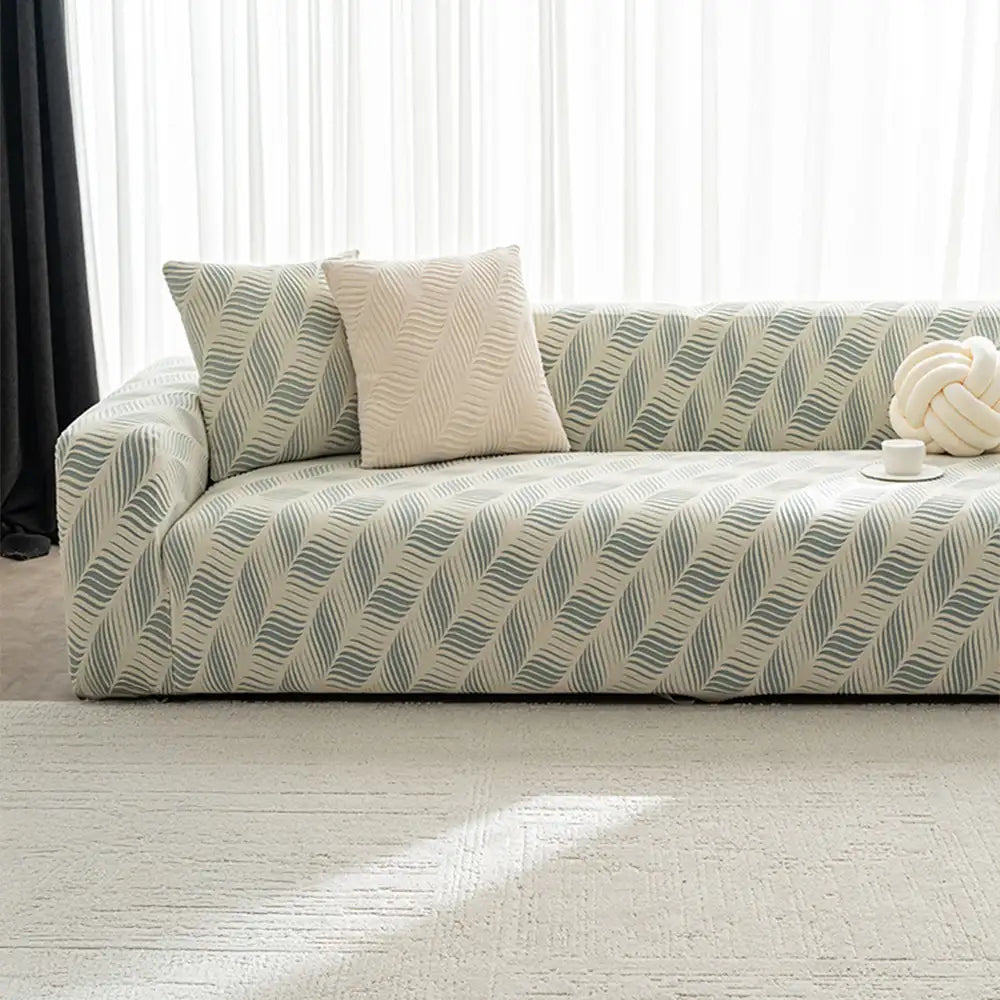 Full view of a couch covered with a unisex polar fleece jacquard sofa cover, pet friendly home decor