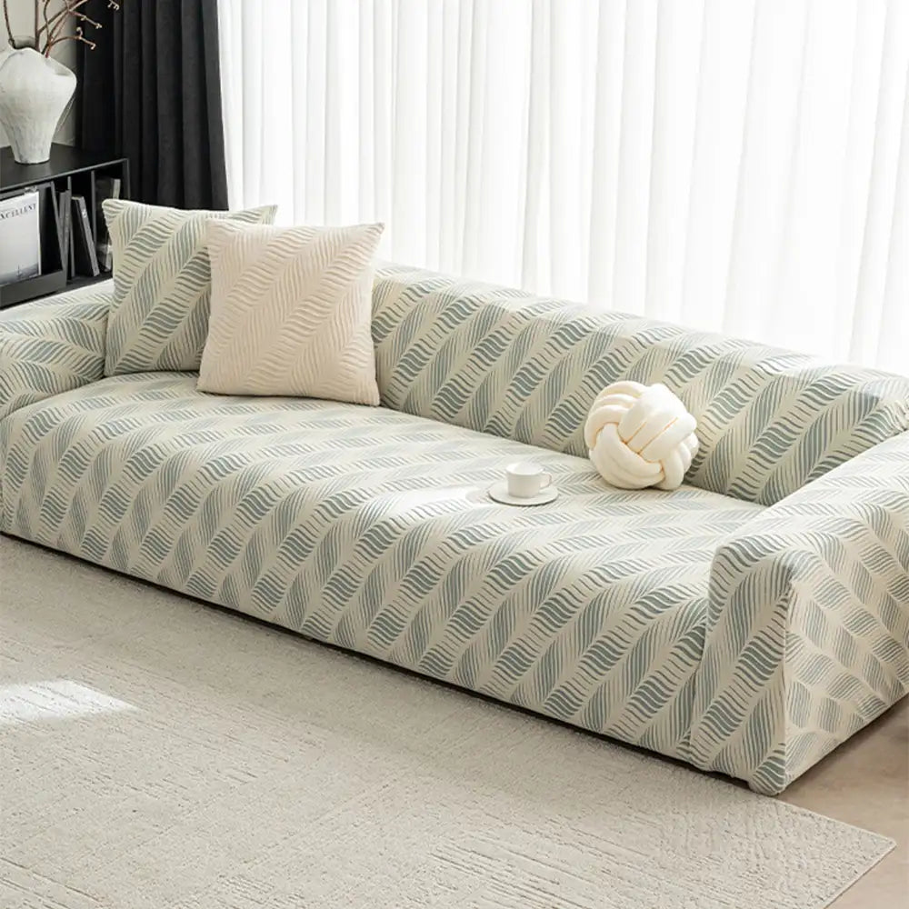 Detail of the elastic band on a stretch jacquard sofa cover, ensuring a snug, anti-scratch fit