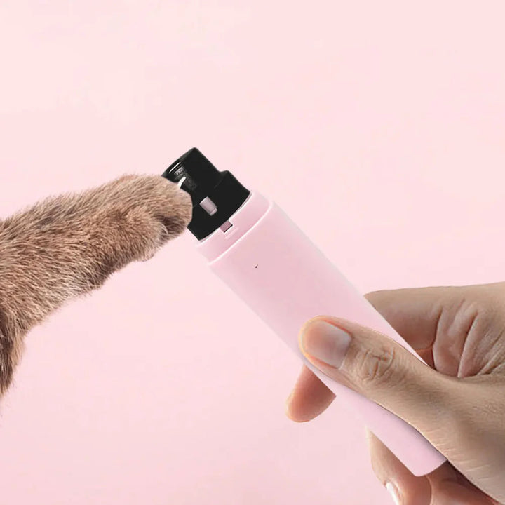 Hand holding a unisex pet nail grinder with LED light, demonstrating ergonomic design for comfort