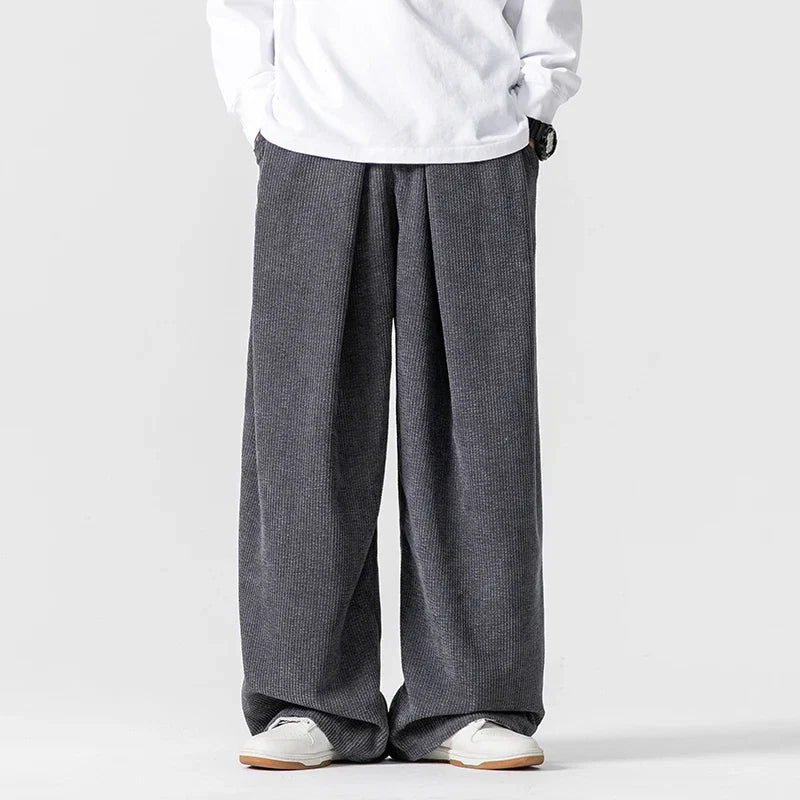Soft pink wide-leg drawstring pants, unisex relaxed fit for stylish comfort & streetwear looks.