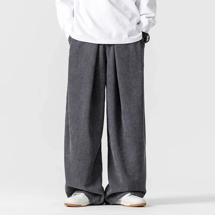 Soft pink wide-leg drawstring pants, unisex relaxed fit for stylish comfort & streetwear looks.