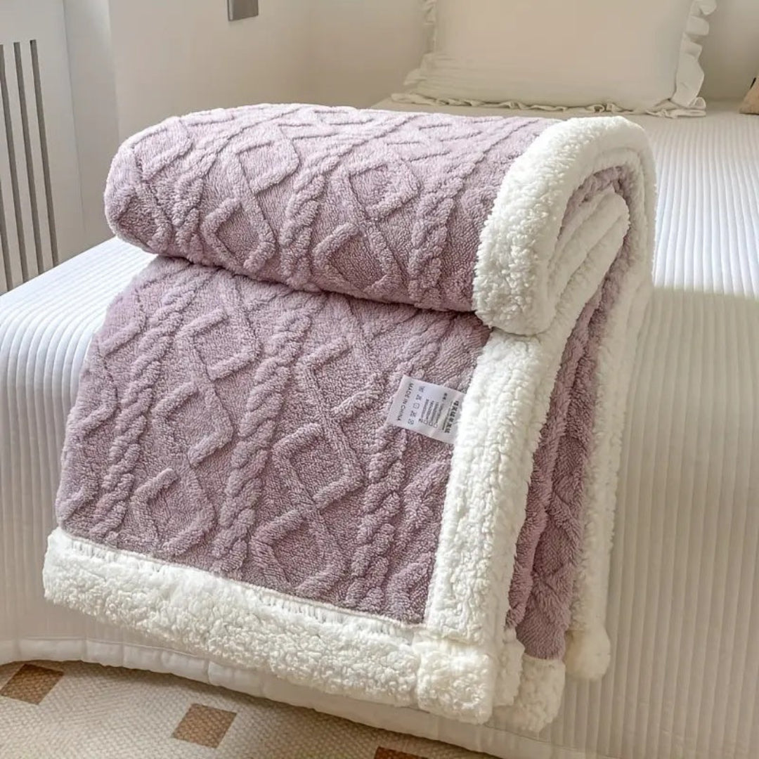 Soft sherpa fleece throw blanket with warm, fuzzy texture, ideal for pets or human use.