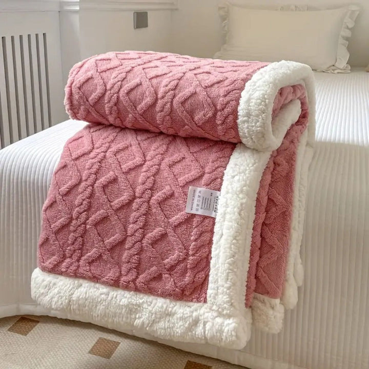 Dual-sided reversible blanket featuring plush sherpa on one side and smooth fleece on the other for comfort.