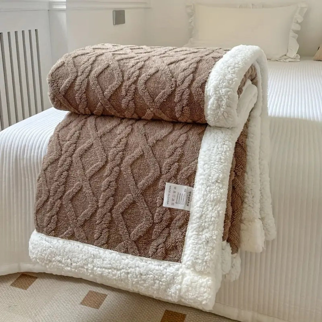 Chic and warm reversible sherpa blanket, a cozy winter warmer for any home decor style.